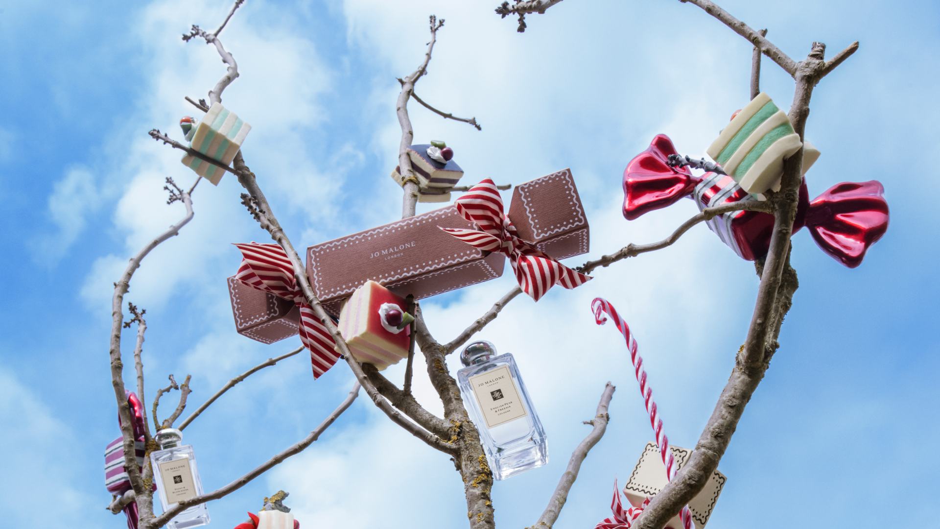 Jo Malone London Gingerbread House Candy Canes and boys running with gifts and ribbon
