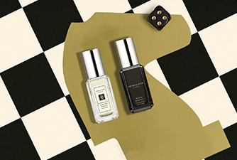 Launch image of advent calendar dartboard box shown open with examples of 5 product contents on checkerboard background.