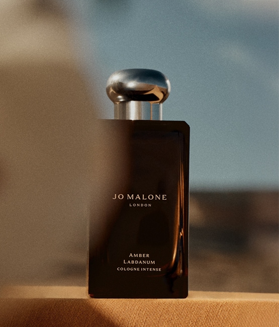 Jo Malone London Sandalwood & Spiced Apricot Colognes 100ml and 30ml on checkered background